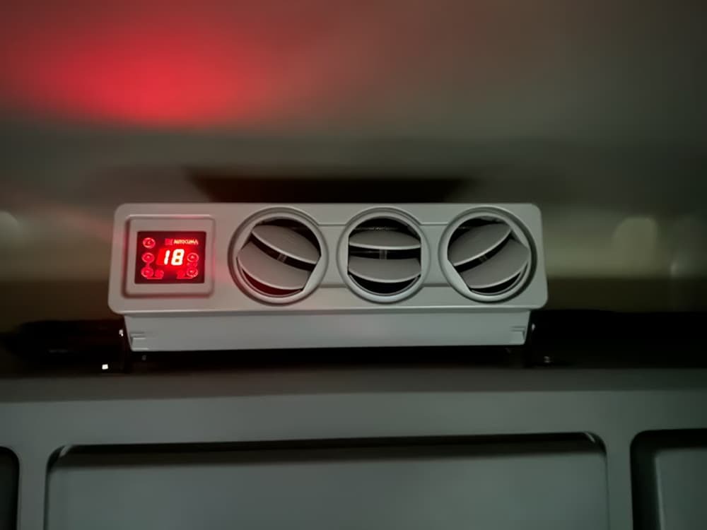 Air conditioning unit with three vents and a digital display.